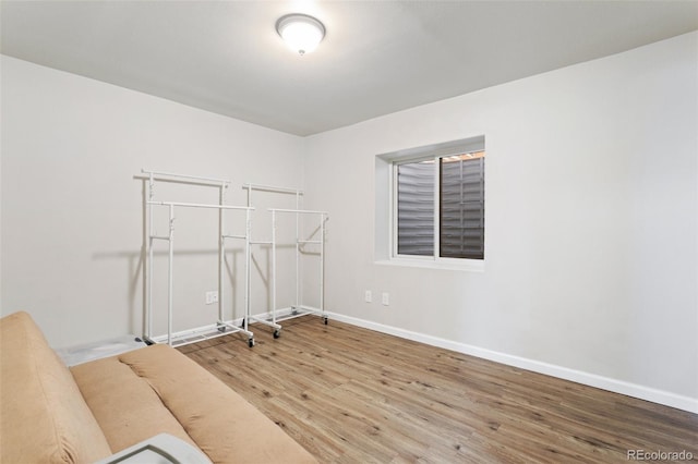 interior space with baseboards and wood finished floors