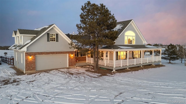 view of front of property featuring covered porch, brick siding, and an attached garage