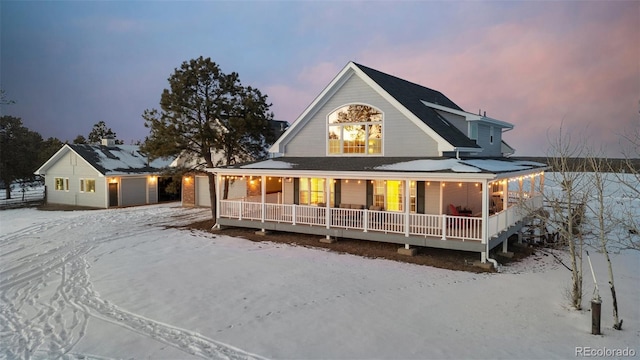 rear view of house with a garage and a porch