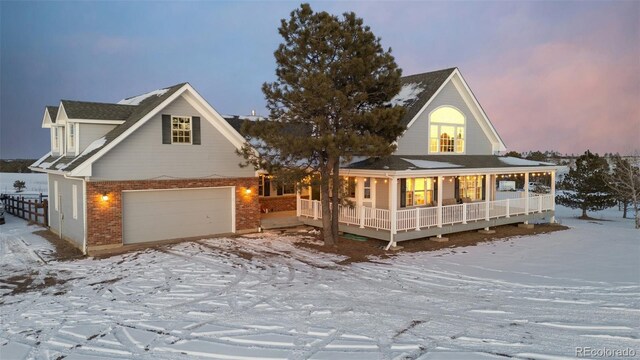 view of front of home featuring a porch and a garage