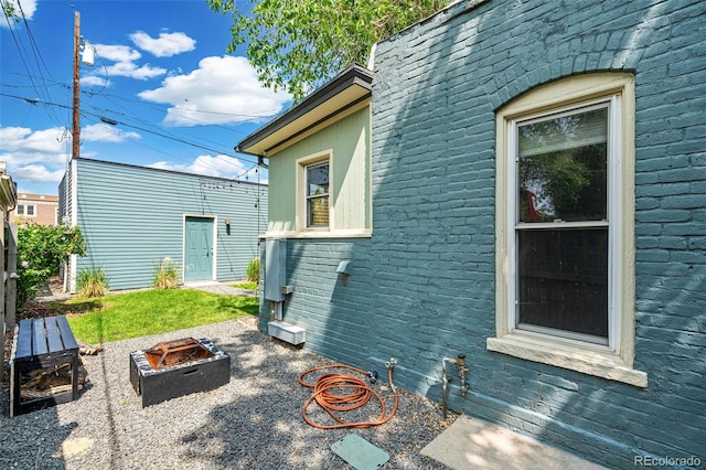 269 Delaware St, Denver, CO 80223 - view of property exterior with a fire pit and brick siding