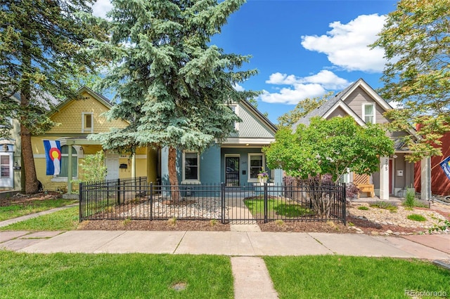 269 Delaware St, Denver, CO 80223 - view of front of house featuring a fenced front yard and a porch