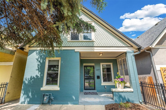 269 Delaware St, Denver, CO 80223 - view of front of property featuring brick siding and covered porch