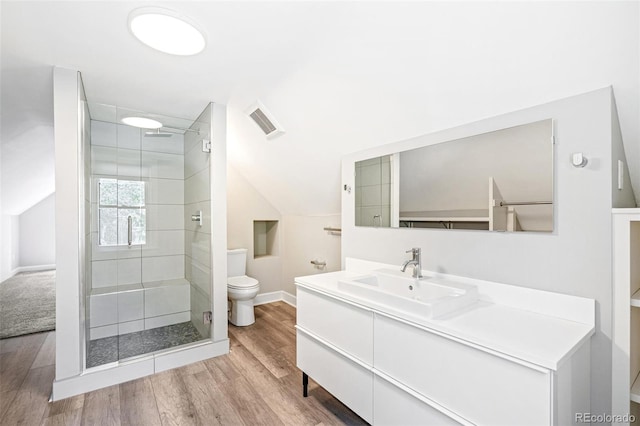 269 Delaware St, Denver, CO 80223 - full bathroom with vanity, a shower stall, wood finished floors, and vaulted ceiling