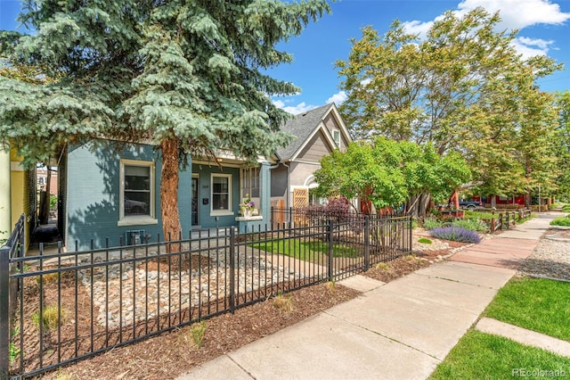 269 Delaware St, Denver, CO 80223 - view of property hidden behind natural elements featuring a fenced front yard