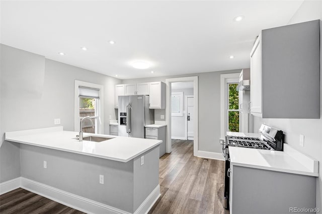269 Delaware St, Denver, CO 80223 - kitchen featuring gas stove, high quality fridge, wood finished floors, plenty of natural light, and recessed lighting