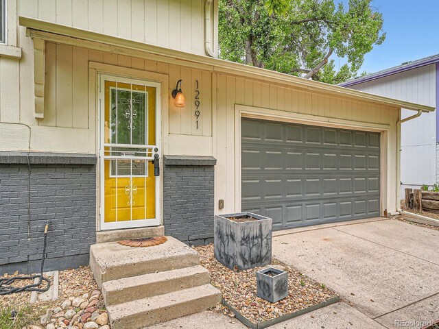 12991 E Idaho Dr, Aurora, CO 80012 - property entrance featuring driveway and brick siding