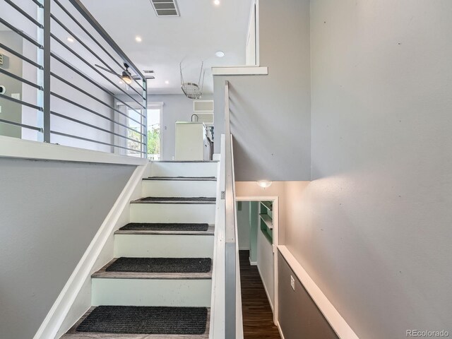 12991 E Idaho Dr, Aurora, CO 80012 - stairway with wood finished floors and recessed lighting