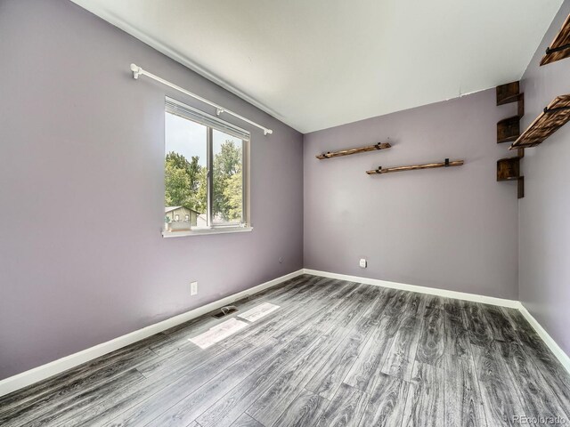 12991 E Idaho Dr, Aurora, CO 80012 - unfurnished room featuring wood finished floors and baseboards