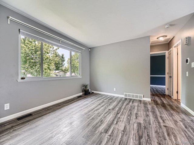 12991 E Idaho Dr, Aurora, CO 80012 - empty room featuring wood finished floors, attic access, and baseboards
