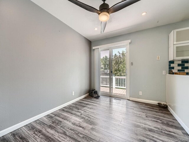 12991 E Idaho Dr, Aurora, CO 80012 - spare room with wood finished floors, baseboards, a ceiling fan, and recessed lighting