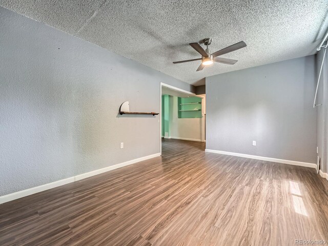 12991 E Idaho Dr, Aurora, CO 80012 - spare room featuring wood finished floors, a ceiling fan, baseboards, a textured ceiling, and a textured wall