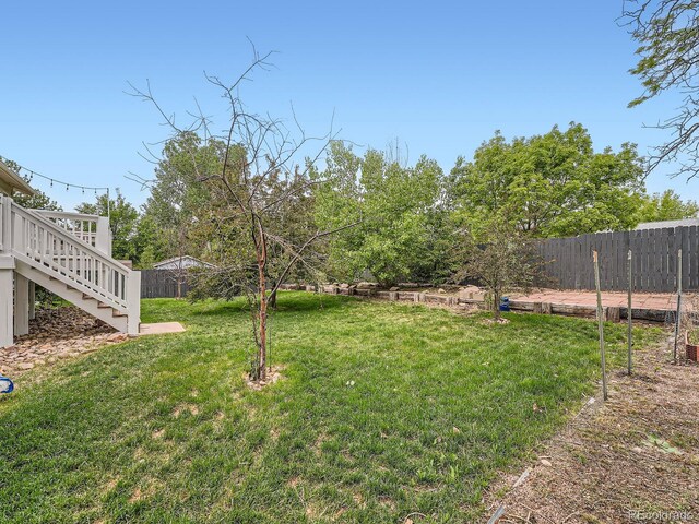 12991 E Idaho Dr, Aurora, CO 80012 - view of yard featuring stairs and a deck