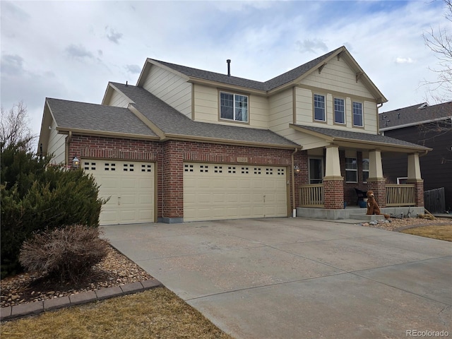 view of front of house with a shingled roof, covered porch, brick siding, and concrete driveway