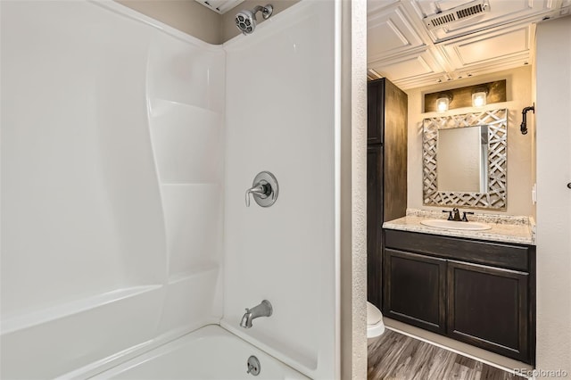 13018 Niagara Way, Thornton, CO 80602 - full bath with toilet, vanity,  shower combination, and wood finished floors