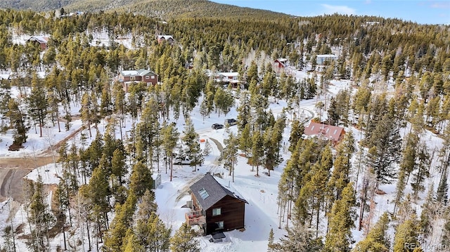 snowy aerial view with a forest view