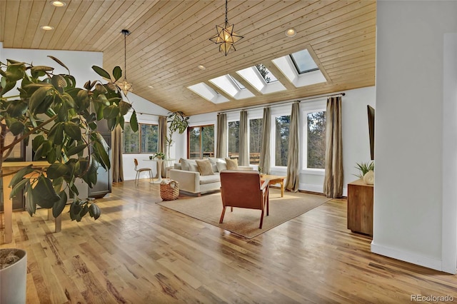 sunroom with vaulted ceiling with skylight, wood ceiling, and plenty of natural light