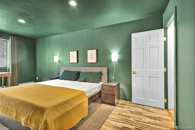 bedroom with recessed lighting and light wood-style floors