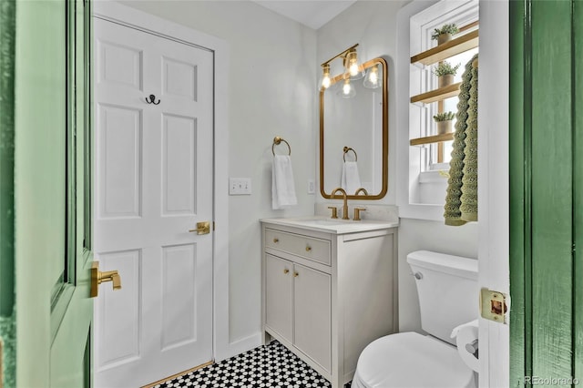 bathroom with toilet and vanity