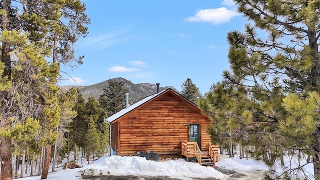 view of snowy exterior with a mountain view