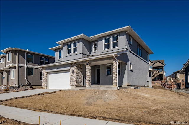 prairie-style home with a garage, concrete driveway, stone siding, a residential view, and stucco siding