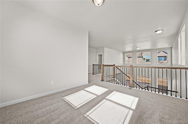 empty room with carpet flooring and baseboards