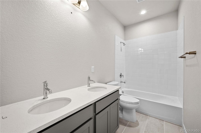 bathroom featuring double vanity, tub / shower combination, a sink, and toilet