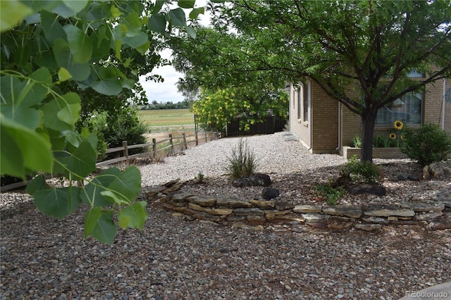 view of yard with a rural view