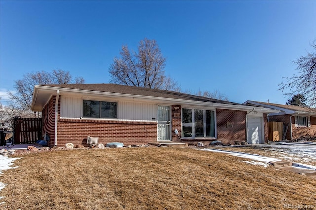 ranch-style home with a garage and a front lawn