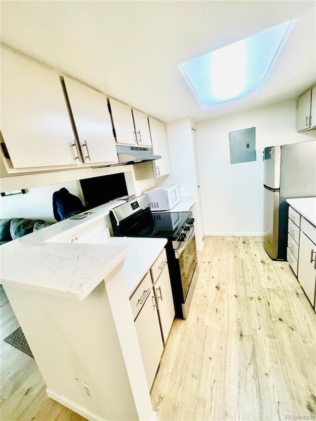 14413 E Jewell Ave Unit 201, Aurora, CO 80012 - kitchen with stainless steel range oven, light wood-style flooring, freestanding refrigerator, under cabinet range hood, and electric panel