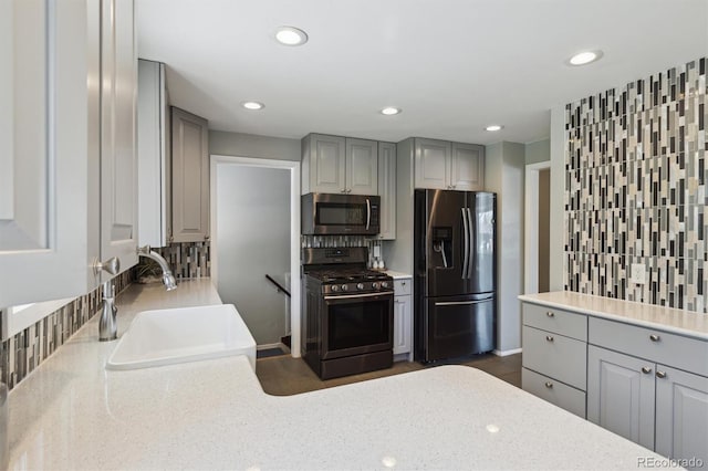 269 Beryl Way, Broomfield, CO 80020 - kitchen with stainless steel appliances, gray cabinetry, a sink, recessed lighting, and light stone counters