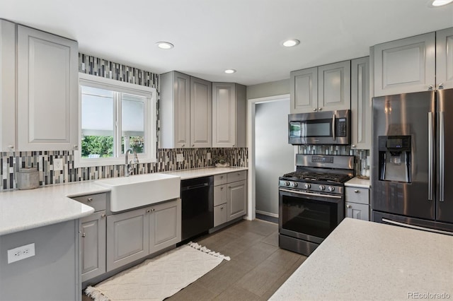 269 Beryl Way, Broomfield, CO 80020 - kitchen featuring appliances with stainless steel finishes, a sink, gray cabinets, backsplash, and recessed lighting