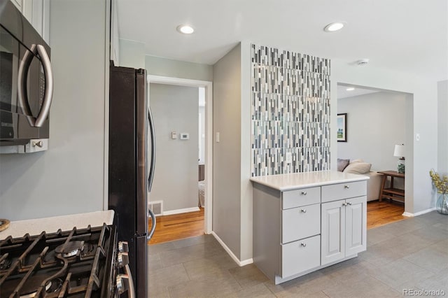 269 Beryl Way, Broomfield, CO 80020 - kitchen featuring appliances with stainless steel finishes, light countertops, baseboards, light tile patterned flooring, and recessed lighting