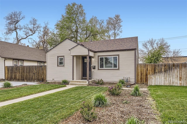 4425 S Lincoln St, Englewood, CO 80113 - bungalow featuring roof with shingles, fence, and a front yard
