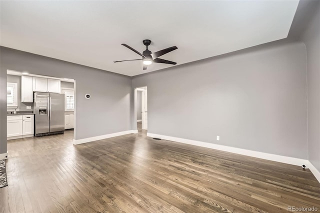 4425 S Lincoln St, Englewood, CO 80113 - unfurnished living room with baseboards, ceiling fan, wood finished floors, and visible vents