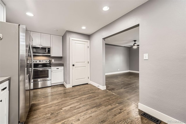 4425 S Lincoln St, Englewood, CO 80113 - kitchen with white cabinets, ceiling fan, dark countertops, stainless steel appliances, and baseboards