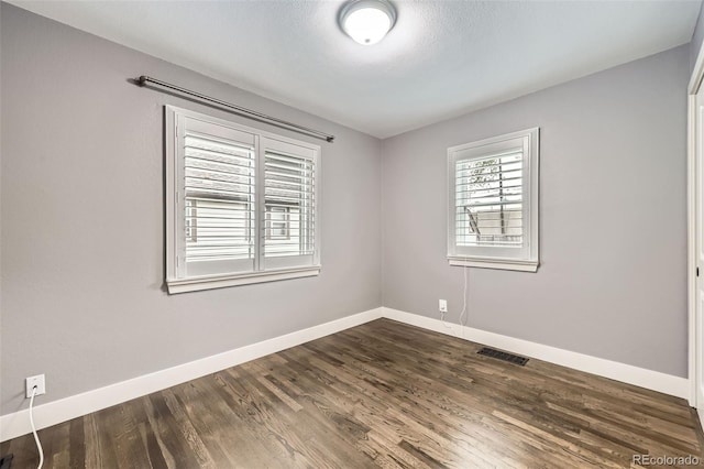 4425 S Lincoln St, Englewood, CO 80113 - unfurnished room featuring baseboards, dark wood finished floors, and visible vents