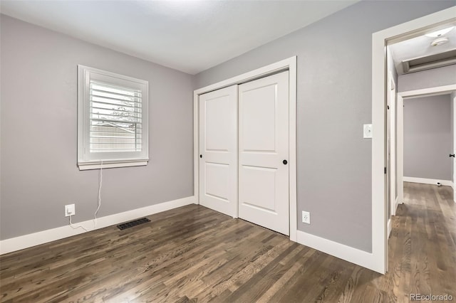 4425 S Lincoln St, Englewood, CO 80113 - unfurnished bedroom with dark wood-style flooring, baseboards, visible vents, and a closet