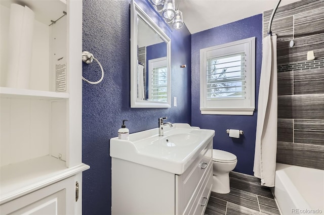 4425 S Lincoln St, Englewood, CO 80113 - full bath featuring toilet, a textured wall, baseboards, and vanity