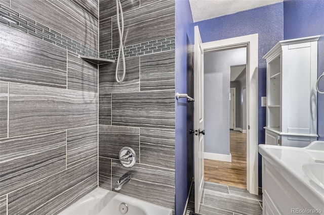 4425 S Lincoln St, Englewood, CO 80113 - bathroom featuring vanity, a textured wall, and shower / bathtub combination