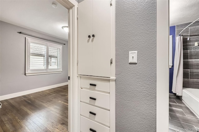 4425 S Lincoln St, Englewood, CO 80113 - hallway with a textured wall, baseboards, and dark wood-type flooring