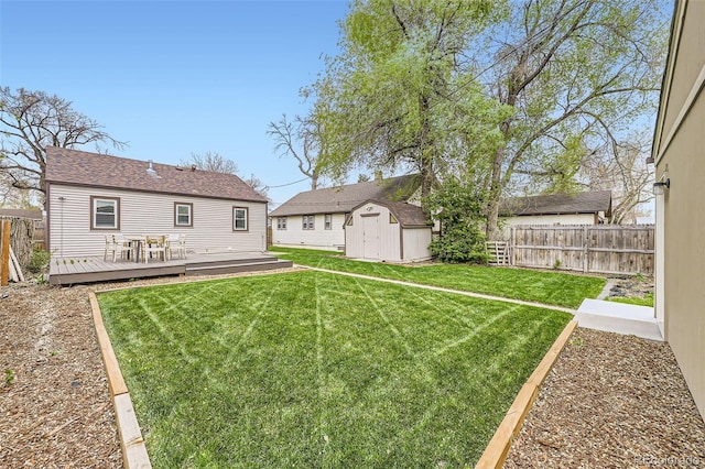 4425 S Lincoln St, Englewood, CO 80113 - view of yard featuring a storage shed, an outbuilding, a wooden deck, and a fenced backyard