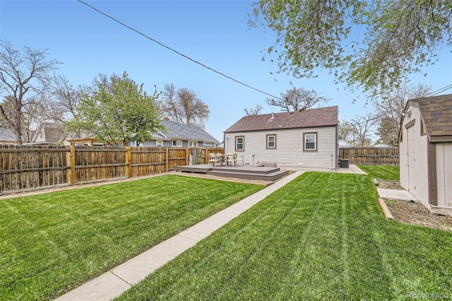 4425 S Lincoln St, Englewood, CO 80113 - back of property featuring a storage shed, a deck, a fenced backyard, an outdoor structure, and a yard