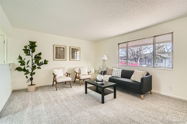 carpeted living room featuring a textured ceiling