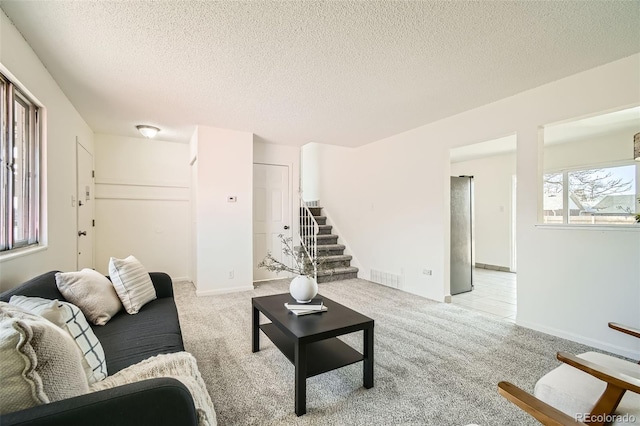 living room with light colored carpet and a textured ceiling