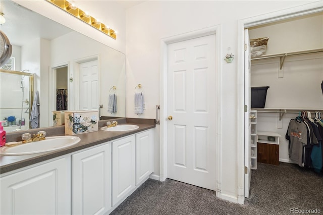 11030 Glacier Park Cir, Parker, CO 80138 - full bathroom with double vanity, a stall shower, a spacious closet, and carpet flooring