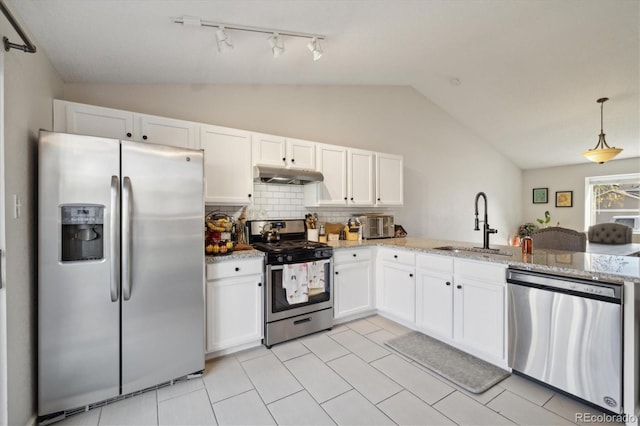 kitchen with light stone countertops, sink, vaulted ceiling, white cabinets, and appliances with stainless steel finishes