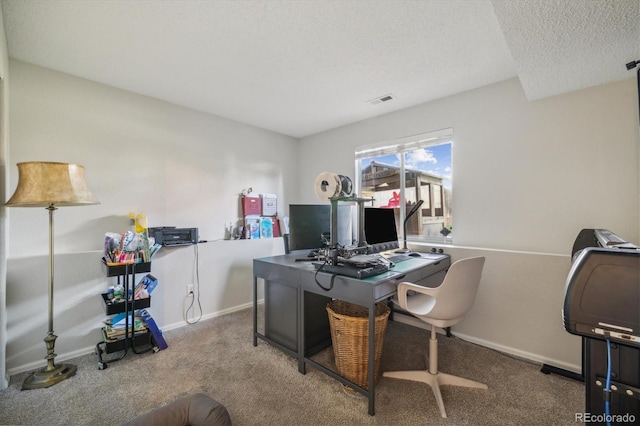 carpeted office featuring a textured ceiling