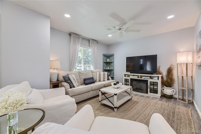 living room featuring hardwood / wood-style floors and ceiling fan