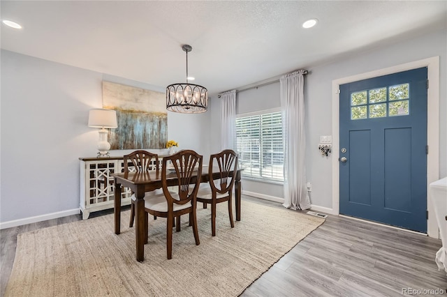 dining area featuring a chandelier, a wealth of natural light, and wood-type flooring